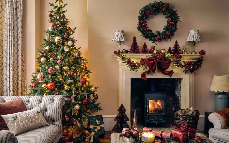 Nouvelles tendances décoration de noël traditionnelle, salon avec poêle en rouge, vert et doré